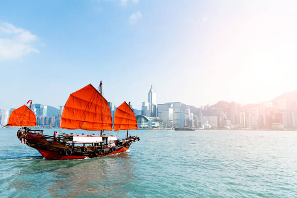 Junk boat crossing Hong Kong harbor.