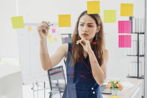 istock Solving problem Concept. woman working together on glass board to thinking ideas for solve her problems. 1130945834