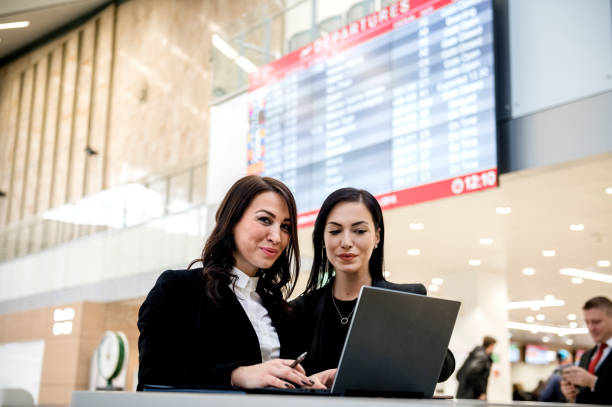 istock Business women's using laptop together at airport 1130946480