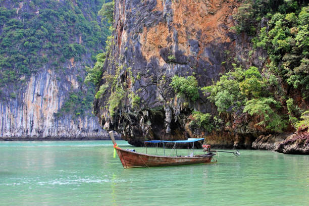 istock Old boat on island in Thailand 1130948815