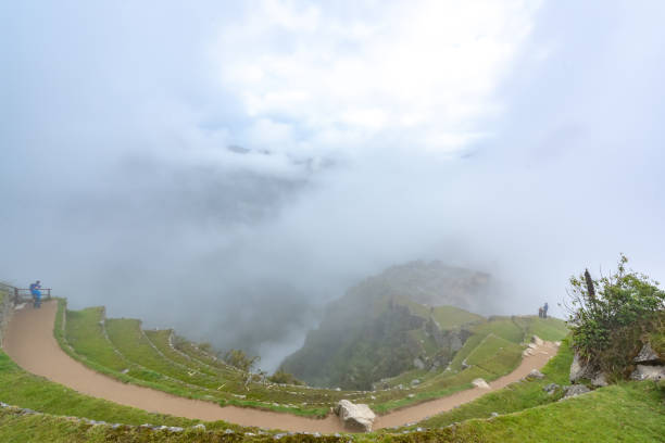 Cusco, Peru - Oct 16, 2018: Machu Picchu aerial view. Tourists are walking through the old abandoned city.