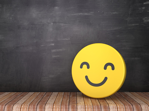 Smile Emoticon on Wood Floor - Chalkboard Background - 3D Rendering