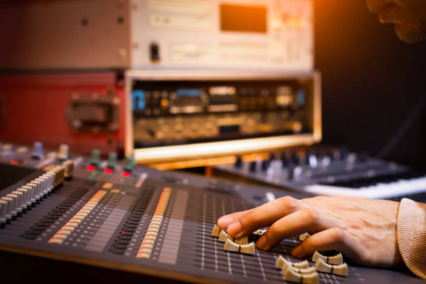 istock male sound engineer, dj hand working on audio mixing console recording, editing, broadcasting studio 1130952849