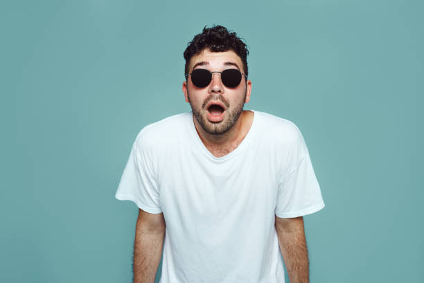 istock Stupefied attractive young bearded man looks with astonishment into camera being amazed with negative news isolated over blue wall 1130953269