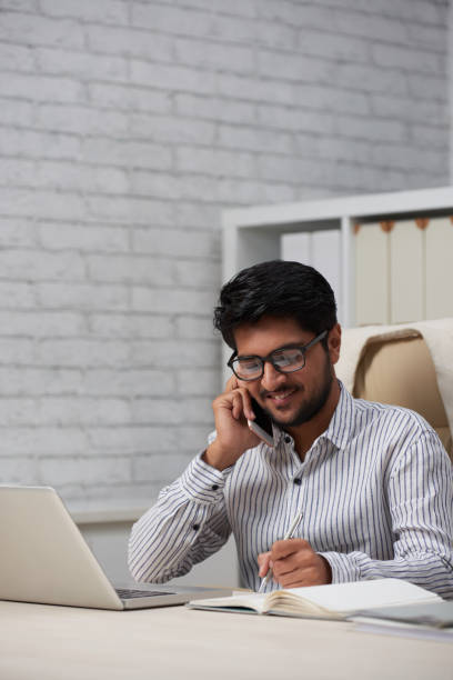 istock Cheerful entrepreneur calling on phone 1130953514