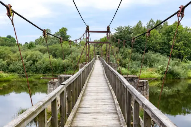 Svencele, Klaipeda county, Lithuania - August 14, 2018: Wooden hanging bridge over King Wilhelm channel. Tourist destination in Klaipeda county in Lithuania.