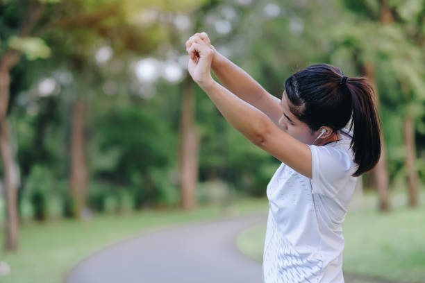 istock Woman Exercising On Road Against Trees 1130955893