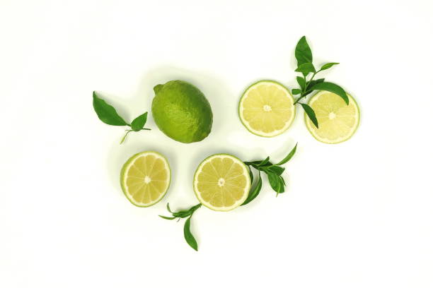 istock sliced lime vith leaves isolated on white background .Top view. Flat lay 1130956426