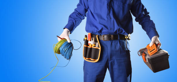 istock Background uniformed electrician with tools and electrical equipment only body 1130957249