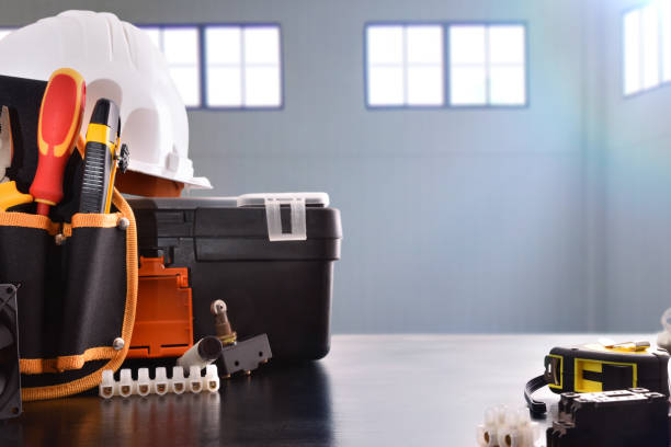 istock Composition with tools and electrical equipment and industrial ship background 1130957265