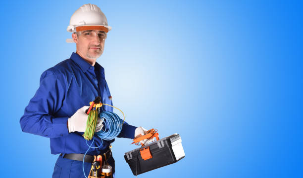 istock Uniformed electrician with safety protections and work tools background 1130957838