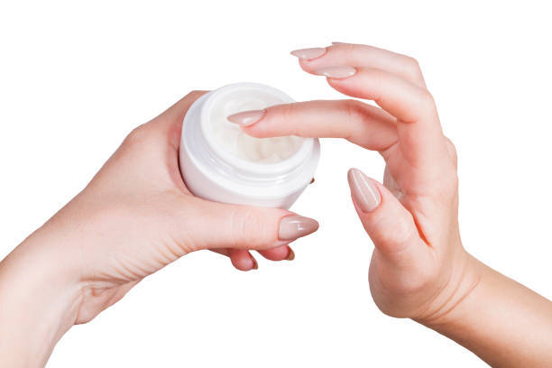 istock female hands are gaining cream from a jar 1130958089