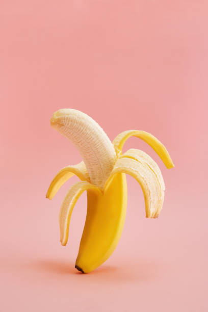 istock Banana peeled on a pink background. 1130959267
