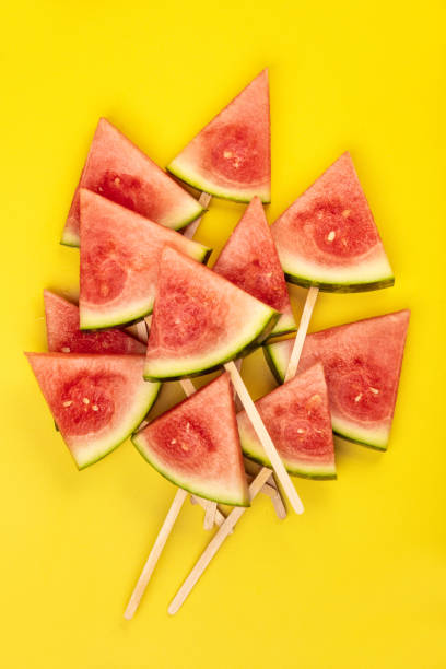 istock Slices of watermelon on yellow background 1130960839