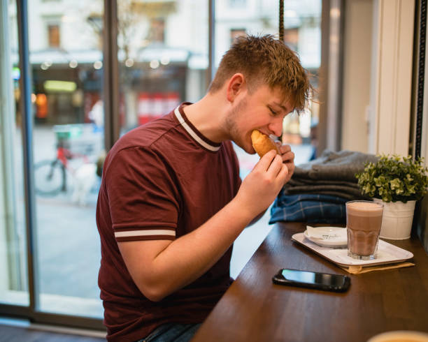 istock Enjoying a Croissant and Hot Drink 1130963195