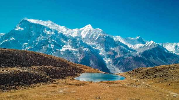 48 MPix XXXXL size panorama of Mount Ama Dablam - probably the most beautiful peak in Himalayas.  This panoramic landscape is an very high resolution multi-frame composite and is suitable for large scale printing. Ama Dablam is a mountain in the Himalaya range of eastern Nepal. The main peak is 6,812  metres, the lower western peak is 5,563 metres. Ama Dablam means  'Mother's neclace'; the long ridges on each side like the arms of a mother (ama) protecting  her child, and the hanging glacier thought of as the dablam, the traditional double-pendant  containing pictures of the gods, worn by Sherpa women. For several days, Ama Dablam dominates  the eastern sky for anyone trekking to Mount Everest basecamp