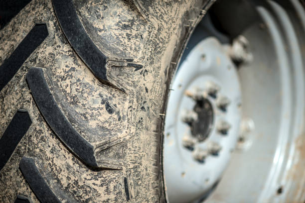 Tractor on the street. Rubber tire from the  tractor, bulldozer or other construction equipment