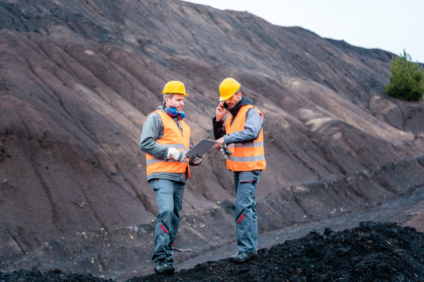 Workers in open-cast mining operation pit stock photo