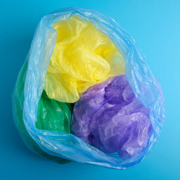 istock bag garbage. Rubbish, Plastic Bags isolated on background blue 1130967875