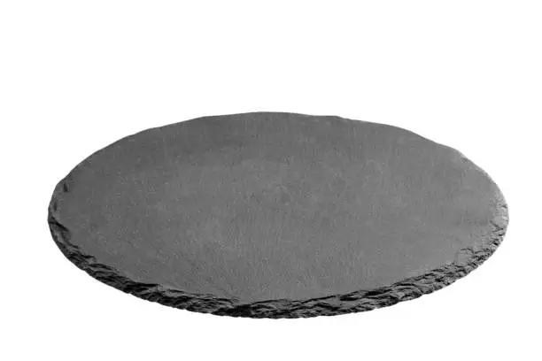 Photo of Slate plate on table. black slate stone isolated on white background. copy space