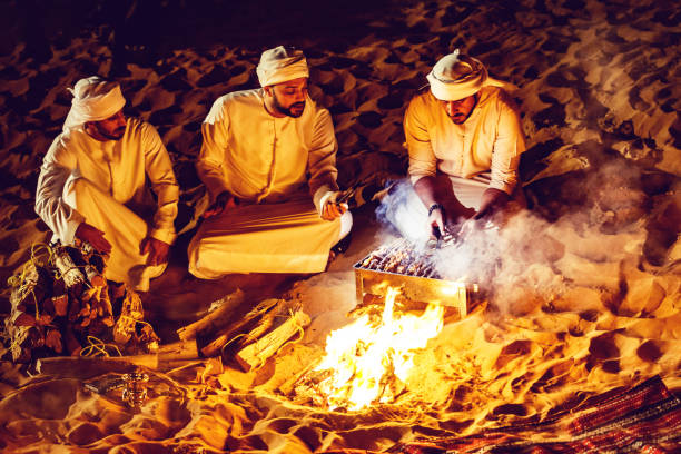 istock Arab Friends Enjoying Bonfire at a Desert Camp 1130968928