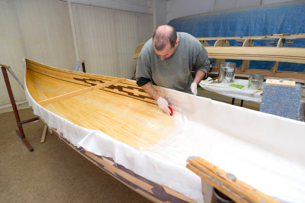 istock Carpenter making wooden canoe in his workshop 1130970905