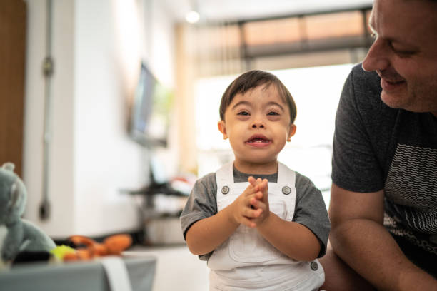 istock Father Playing with Down Syndrome Son at Home 1130971120
