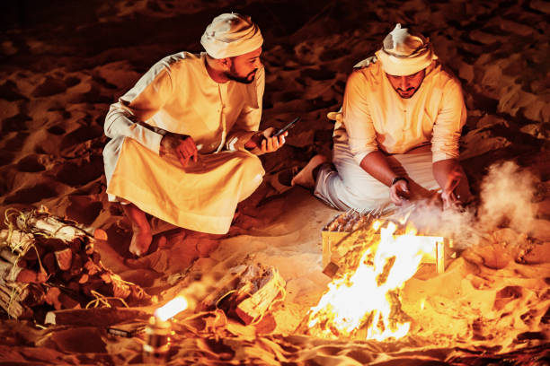 istock Arab Friends Enjoying Bonfire at a Desert Camp 1130971373