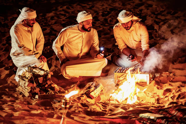 istock Arab Friends Enjoying Bonfire at a Desert Camp 1130972651