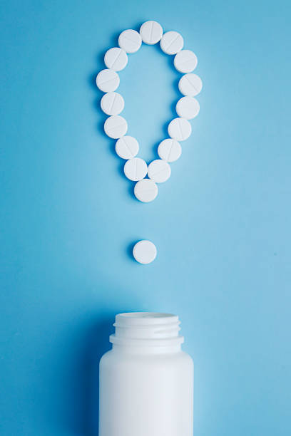 istock White pills in a exclamation mark poured from a medicine bottle on blue background. Medication and prescription pills. Important information on medical topics. Top view. Flat lay. 1130972763