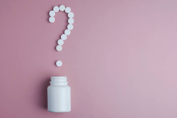 istock A question mark, laid out of pills and a white plastic bottle on a pink background. Medical concept. Copy space. Pink background 1130972767