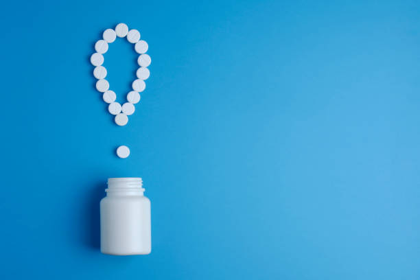 istock White pills in a exclamation mark poured from a medicine bottle on blue background. Medication and prescription pills. Important information on medical topics. Top view. Flat lay. 1130972775