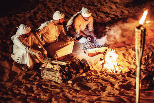 istock Arab Friends Enjoying Bonfire at a Desert Camp 1130973002