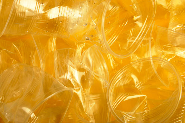 istock used plastic cup on yellow background, copy space for your text 1130973258