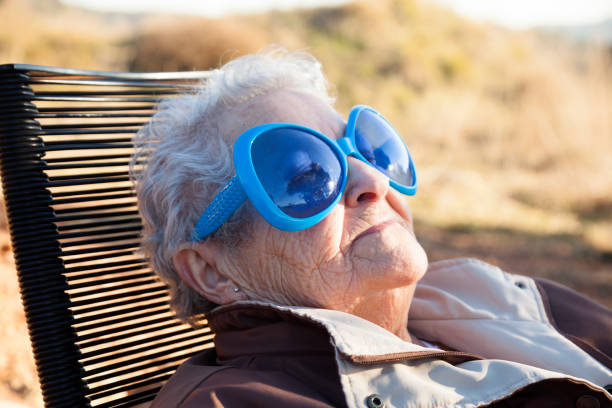 Grandmother sunbathing with pretty glasses