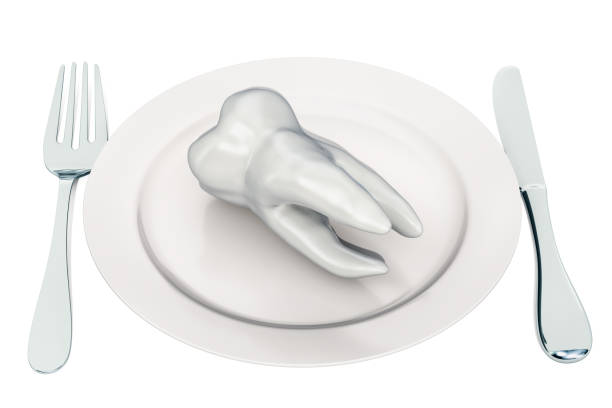 istock Tooth on the plate. 3D rendering isolated on white background 1130977108