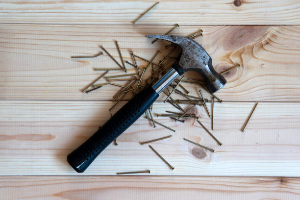 istock work tool iron hammer with a black rubber grip lying on a wooden table 1130981285