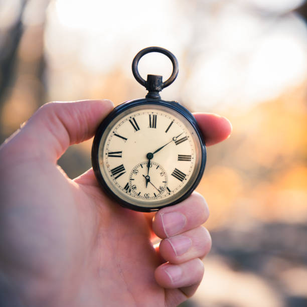 istock Hand held stop watch outdoors, autumn, blurry background 1130982604