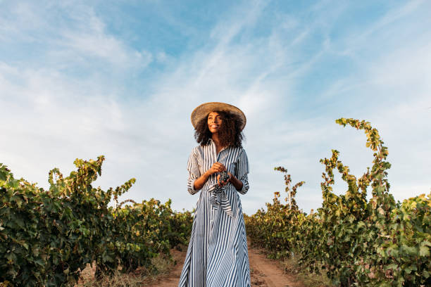 Young woman walking in a path in the middle of a vineyard stock photo