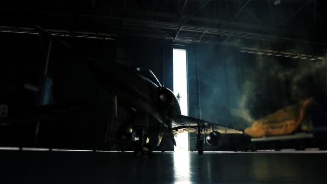 Fighter Plane Inside A Military Hangar Awaiting Deployment.