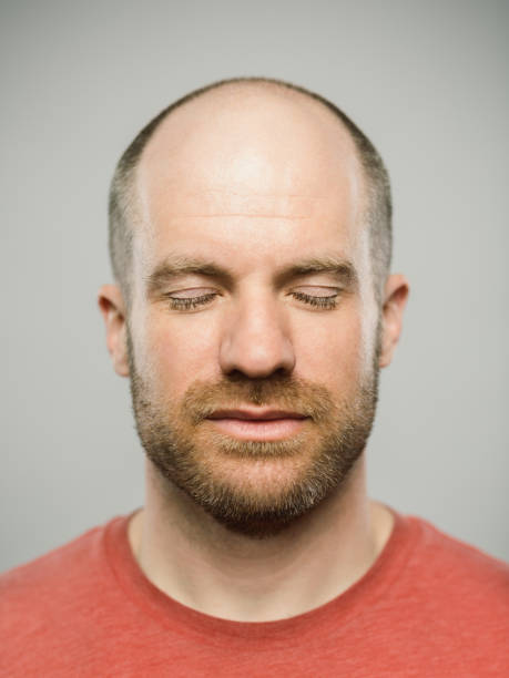 istock Real caucasian man with blank expression and eyes closed 1130984859