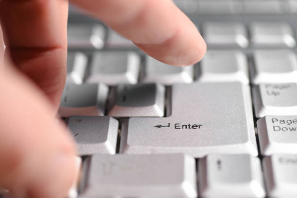 istock Finger hand presses the Enter button on the keyboard, close-up 1130985032