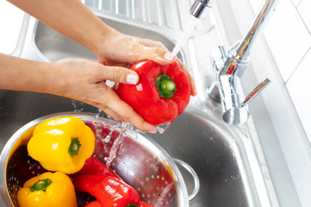 istock Peppers being washed in a kitchen sink 1130988304