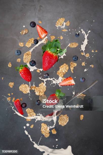 Breakfast Levitation Cereal With Strawberry And Blueberry Milk Splashes Of Milk Stock Photo - Download Image Now