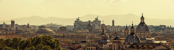 Panoramic skyline of Rome with ancient architecture at sunset stock photo