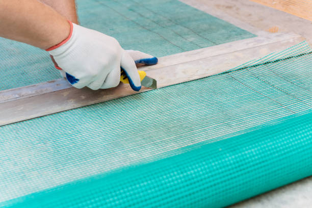 istock A worker is cutting  a fiberglass mesh. 1130989890