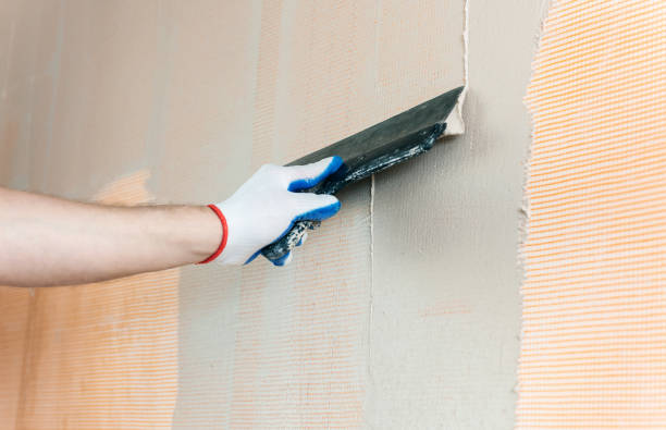 istock The worker's hand with a wide spatula. 1130990559