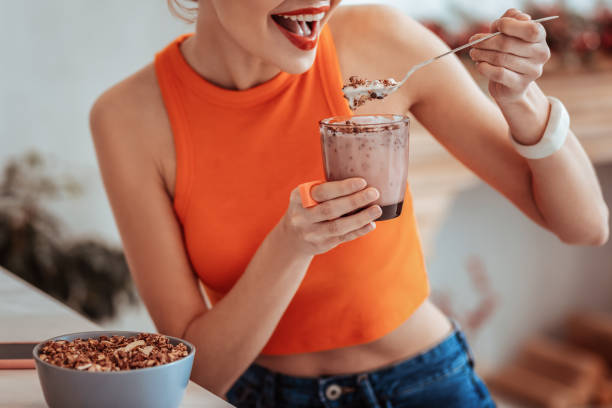 istock Joyful nice woman holding a glass with muesli 1130990693
