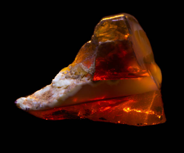 istock Natural piece of fire red opal on a black background isolated 1130990738