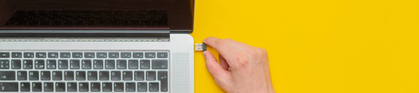 istock persons hand insert usb wire in a laptop isolated b 1130990811